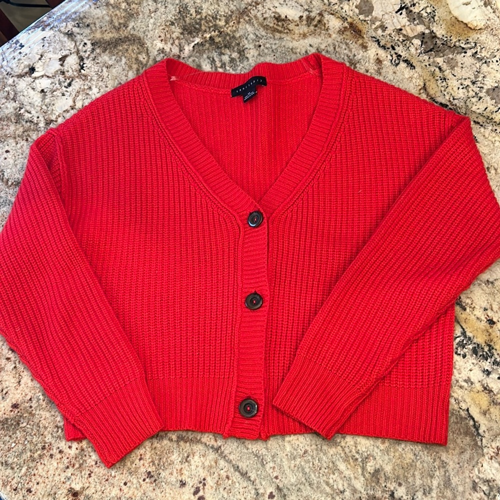 Red cardigan sweater.